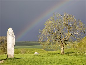 Rainbow over standing stones at Avebury, Wiltshire, England, UK