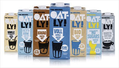 Oatly different types of vegan oat milk cropped against a white background