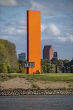 The sculpture Rhine Orange at the mouth of the Ruhr into the Rhine, skyline of the city centre of