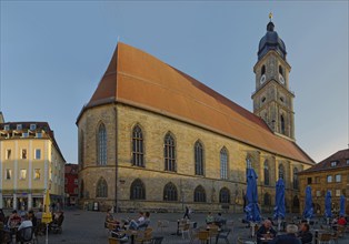 Lively market square with cafés and St Martin's Basilica in the evening light, Amberg, Upper