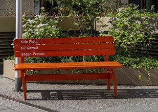 No violence against woman, wooden bench in orange, Berlin, Germany, Europe