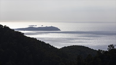 Foggy morning atmosphere in the bay of Sant Antoni, in the background the island of Conillera,