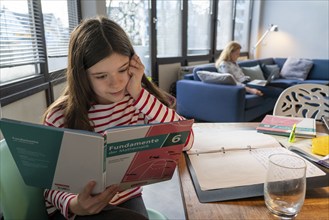 Homeschooling, during the lockdown in January 2021, children learning at home for school, a girl in