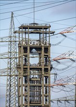 Headframe of the former, disused Walsum colliery, electricity pylons of the STEAG coal-fired power