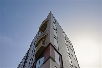 Corner of a modern building with large windows and balconies, sky in the background, Sandnes, Fylke