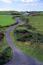 Winding country road passing rural farmhouse, Dursey Head, Beara peninsula, County Cork, Ireland,