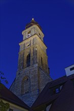 The evening sky is illuminated by the striking church tower of St Martin's Basilica, Amberg, Upper