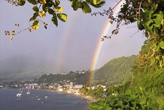 Double rainbow over beach and the town Saint-Pierre, first permanent French colony on the island of