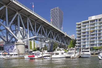 Sailing ships, pleasure craft and multi-storey houses, Burrard Bridge, False Arm, Vancouver,