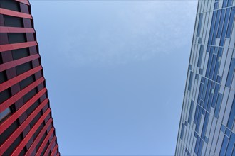 Contrast between a red and a grey modern building against a clear blue sky, Sandnes, Fylke