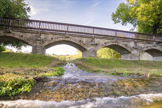 Landscape photograph of a stone bridge over a flowing river, Allstedt, Harz, Germany, Europe