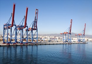 Cranes standing on quayside in the port of Malaga, Spain, Europe