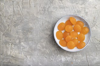 Jelly pumpkin candies on gray concrete background. copy space, top view, flat lay. autumn concept