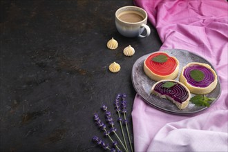 Sweet tartlets with jelly and milk cream with cup of coffee on a black concrete background and pink