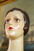 Female mannequin head close up 1920s haircut style, inside antiques centre, Marlesford Mill,