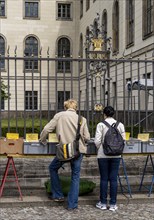 Tourists at the flea market stall in front of Humboldt University, Unter den Linden, Berlin,