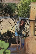 Amhara region, child drinking water at a well, Ethiopia, Africa