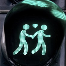 Green pedestrian traffic light with two men and heart, male traffic light couple, homosexual love,