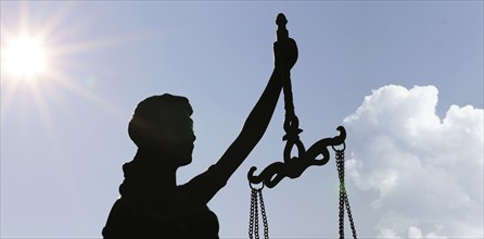 Close-up of a Justitia in front of a blue sky