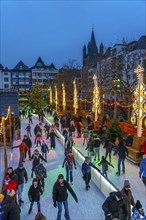 Ice rink at the Christmas market on the Heumarkt in the old town of Cologne, Sunday shopping in