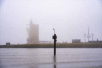 Thick fog in winter, hanging over the mouth of the Elbe into the North Sea, radar tower of the