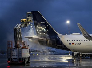 Winter at Frankfurt Main Airport, FRA, Lufthansa aircraft being de-iced by de-icing vehicles,