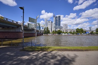 Untermainbrücke, signpost, riverside promenade, Main and skyscrapers under blue sky with cumulus