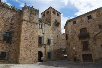 A historic stone building with a tower under a cloudy sky, palace, Palacio de los Golfinos de