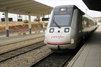 RENFE train arriving at platform of railway station, Caceres, Extremadura, Spain, Europe