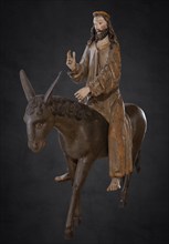 Palm tree donkey, wooden figure from 1470, on a dark background, Franciscan Museum, Villingen,