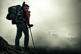 Mountaineer with luggage in the background Rätikon mountains with cloudy sky, Tschagguns, Rätikon,