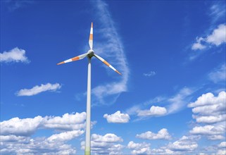 Wind turbine, wind energy plant from the manufacturer Enercon, blue sky with many white clouds,