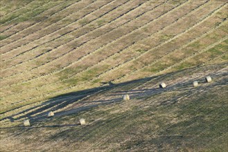 Harvested wheat field with bales of straw, landscape around Pienza, Val d'Orcia, Orcia Valley,