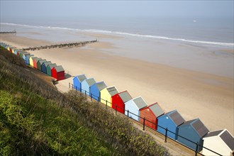 Colourful beach huts, wide sandy beach and sea, Mundesley, Norfolk, England, United Kingdom, Europe