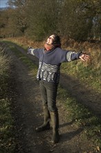 Model released woman enjoying winter sun in the countryside