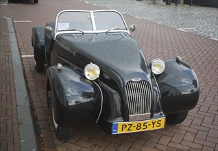 Burton brand self-assembly kit open top car parked on street Netherlands