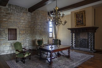 Kasteel van Laarne, interior showing room with antique furniture inside 14th century medieval