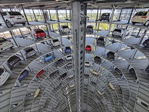 An illuminated car tower with new cars for delivery in the evening, detail, Autostadt, Volkswagen