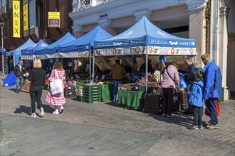 Market stalls on town centre street, The Cornhill, Ipswich, Suffolk, England, UK