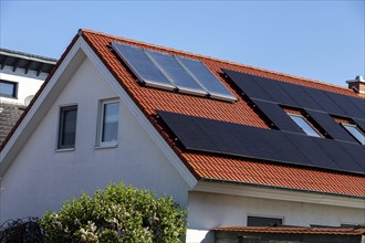 Detached house with photovoltaic system and collectors for solar thermal energy