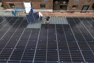 Installation of solar modules on the roof of a barn on a farm, over 210 photovoltaic modules are