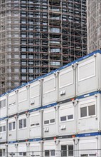 Large construction site, construction of a high-rise residential building, scaffolded shell,