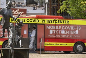 Mobile test centre for Corona rapid tests, in a bus, in the city centre of Bochum, North