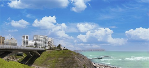 Peru, Lima, scenic ocean view and Miraflores Malecon promenade with shopping malls cafes and