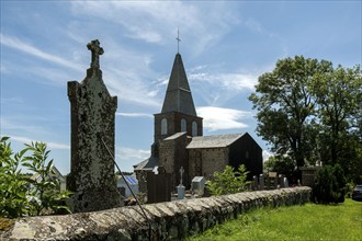 Cemetery of Saint-Victor la Rivière near the church under a clear blue sky in Puy-de-Dôme, Auvergne