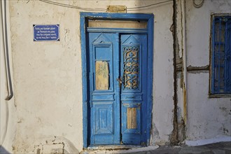 Detail of an old blue wooden door of a historic building, Pyles village, west coast, Karpathos,