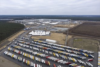 View of the Tesla Giga Factory site, with containers and swap trailers in the foreground,