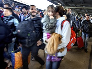 Syrian refugees arrive at Schönefeld station on a special train. They are then taken by bus to