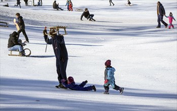 Tobogganing fun in Berlin's snow-covered Viktoriapark. Snow and icy cold continue to dominate the