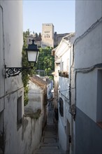 Narrow alleyway named Candil in the Moorish housing district of Albaicin, Granada, Spain with a